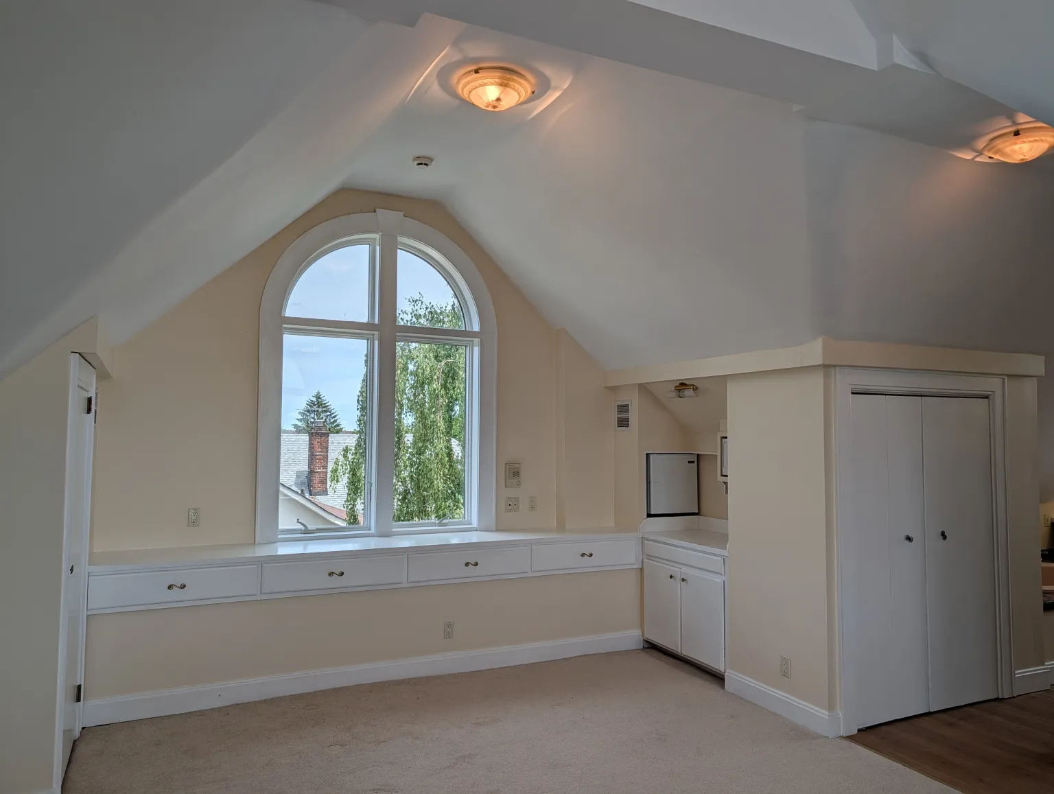 The open third-floor suite under the vaulted ceiling, looking east