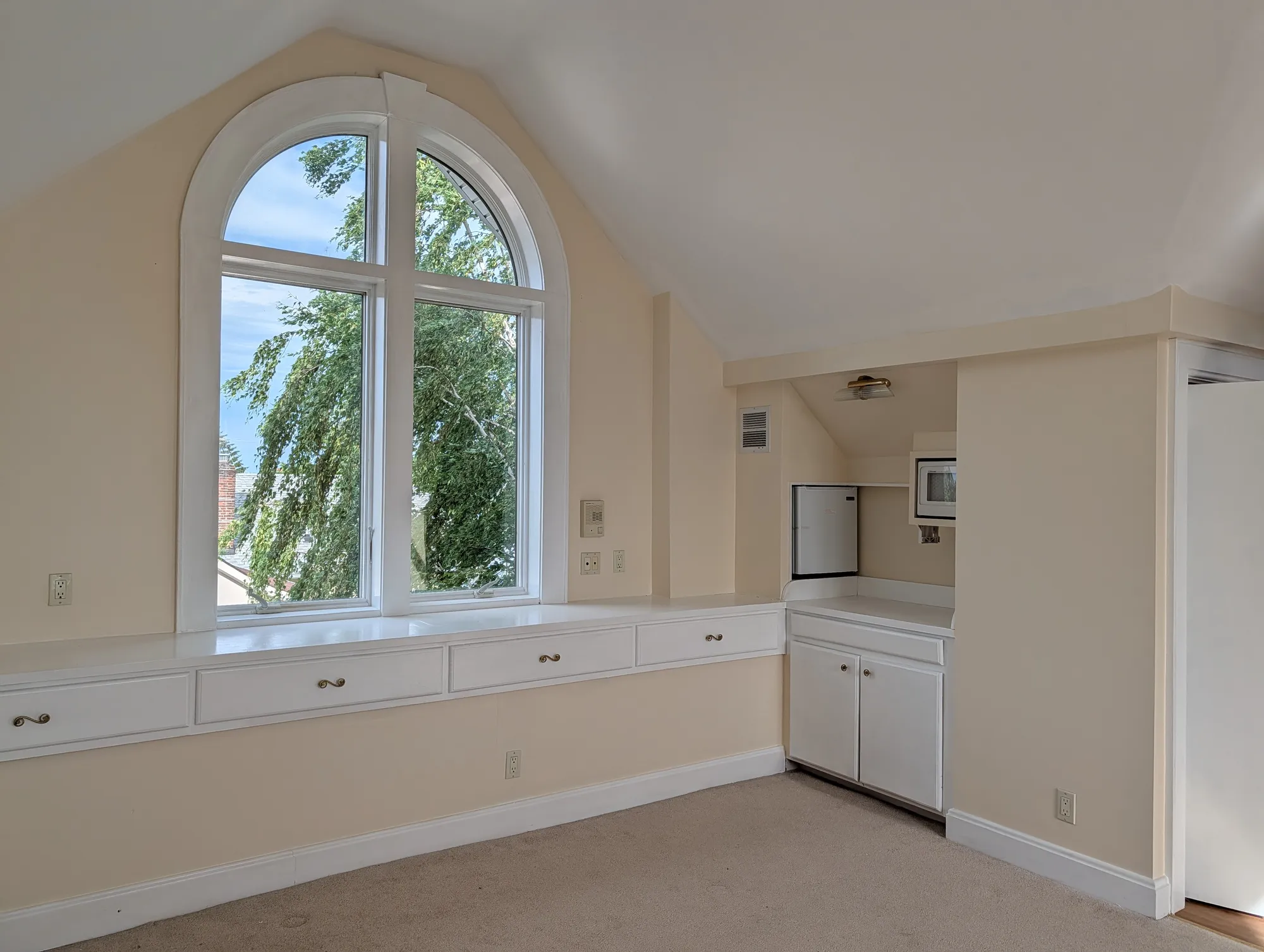 The southeast corner of the suite under the vaulted ceiling, with the kitchenette built into the corner